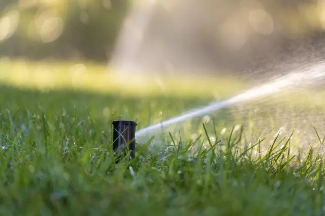 Automatic sprinkler system watering a green lawn in Montclair, NJ