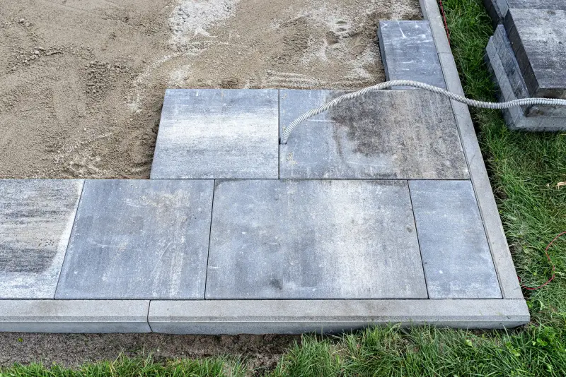 Paver patio installation in progress on a Montclair, NJ landscape construction project